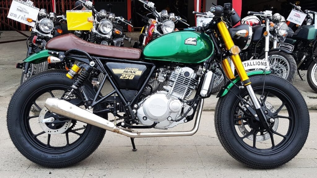 A green motorcycle parked in front of other motorcycles.