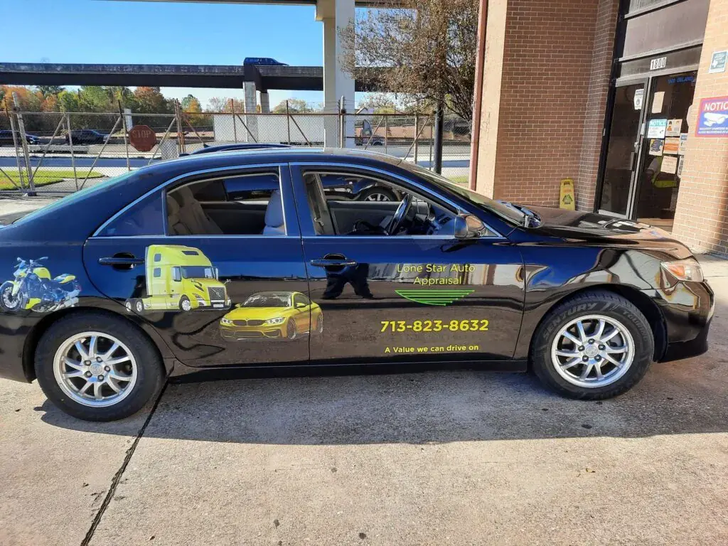A blue car parked on the side of a road.